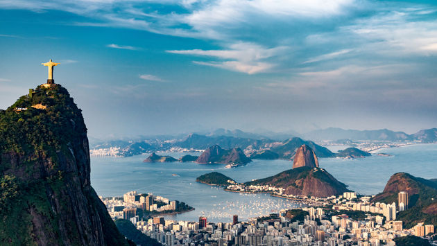 Aerial view of Rio De Janeiro. Corcovado mountain with statue of Christ the Redeemer, urban areas of Botafogo, Flamengo and Centro, Sugarloaf mountain. (photo via microgen / iStock / Getty Images Plus)