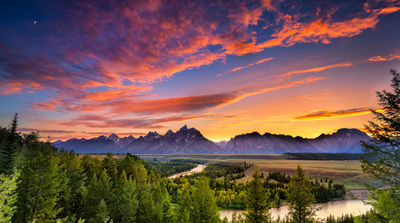 Colorful sunset at Snake River Overlook in Grand Teton National Park, WY (photo via Dean_Fikar / iStock / Getty Images Plus)