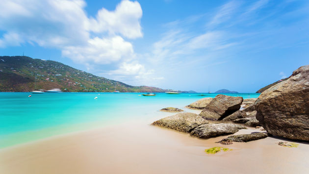 Idyllic beach at Magens Bay, Saint Thomas, US Virgin Islands. This beach is considered one of the best top ten beaches in the world. Paradise and clear water for relaxation. (photo via poladamonte / iStock / Getty Images Plus)