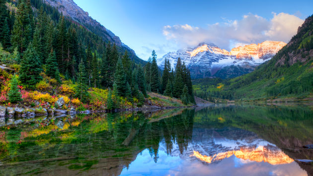 Reflection of Snowcapped Maroon Bells in fall, at sunrise. (Photo via tonda / iStock / Getty Images Plus)