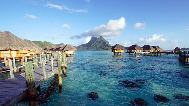 Bora Bora Pearl Beach Resort & Spa's overwater bungalows overlook Mount Pahia and Mount Otemanu