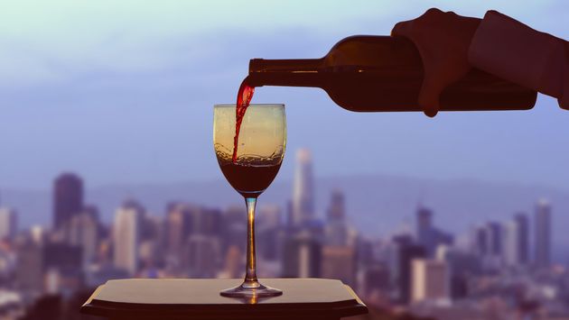 A glass of wine with San Francisco in the background