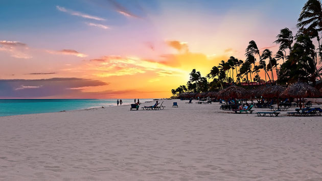 Druif beach at sunset on Aruba island in the Caribbean sea (Photo via Nisangha / iStock / Getty Images Plus)