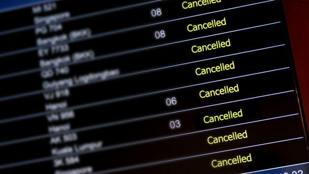 Airport billboard panel with canceled flights.