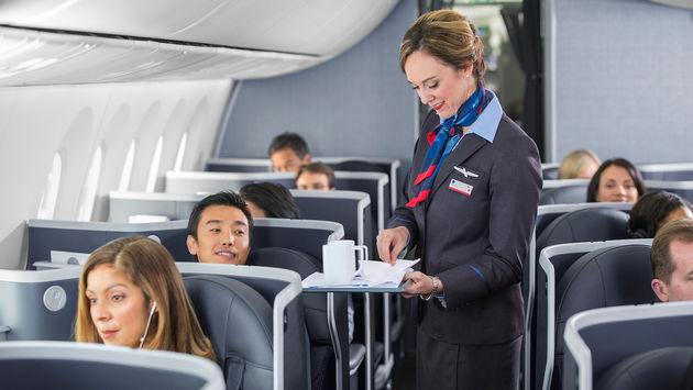 Flight attendant serving coffee aboard an American Airlines flight