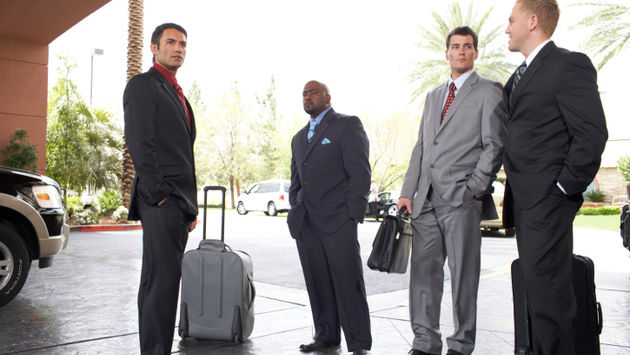 business travelers luggage outside hotel