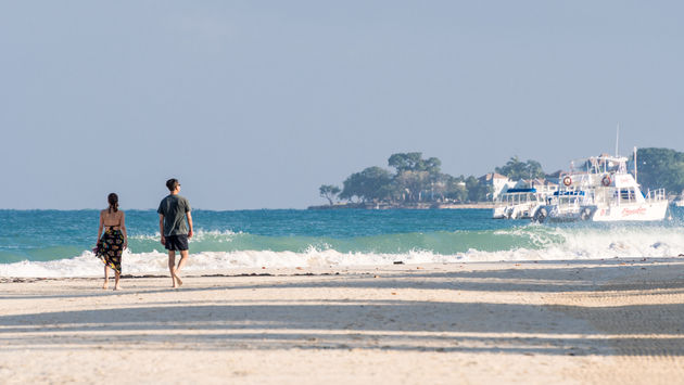 Couple walking Seven Mile Beach in Negril, Jamaica