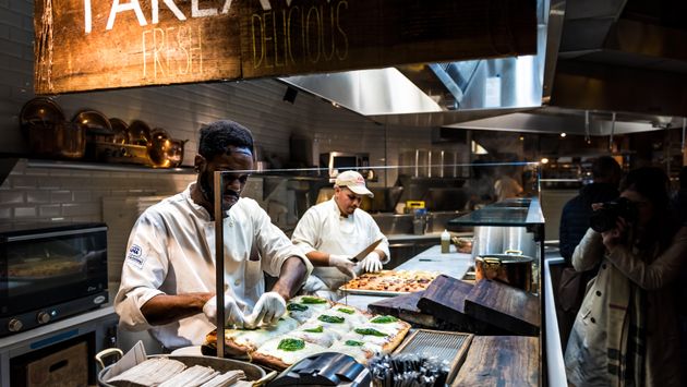Chef cutting focaccia bread pizza in New York City's Chelsea Market