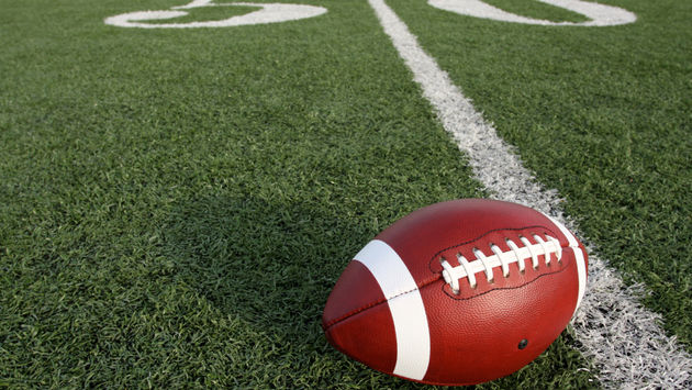 An American football at the fifty-yard line