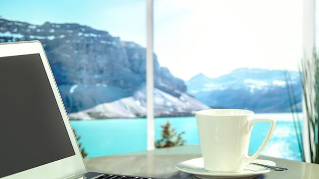 Laptop, mug and scenery