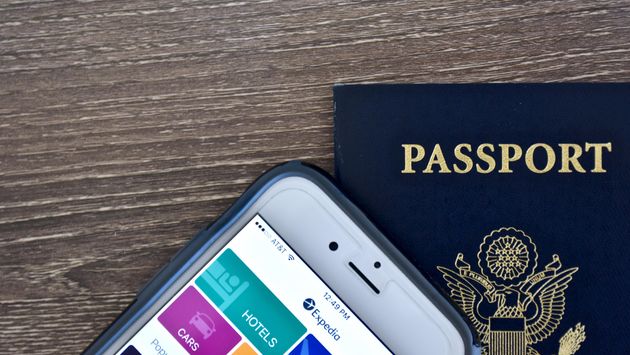 Passport and iPhone with expedia app