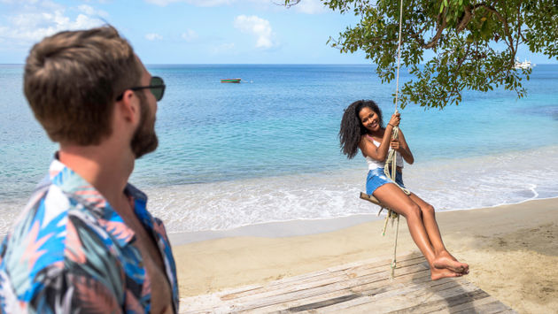 Having fun on a beach rope swing in Grenada