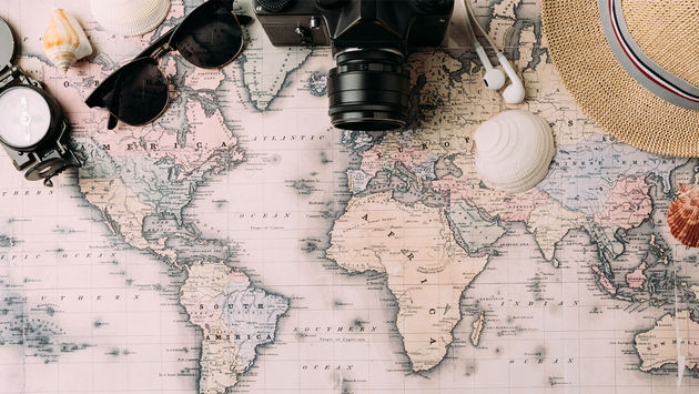 compass, sunglasses, camera, earbuds, hat, shells, world map, globe, global travel