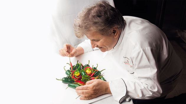Holland America Line’s Master Chef Rudi Sodamin prepares one of his "Food Faces."