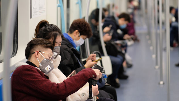 People wearing surgical masks on the subway in Shanghai