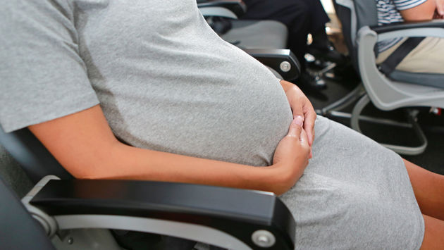 Pregnant woman traveling by plane