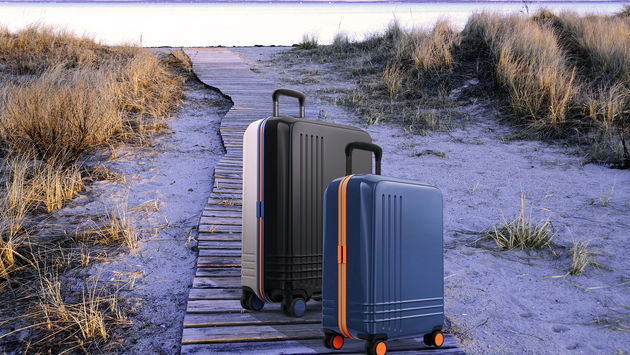 Roam Custom Color Luggage on a beach boardwalk