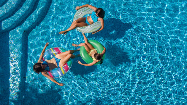 Aerial top view of family in swimming pool