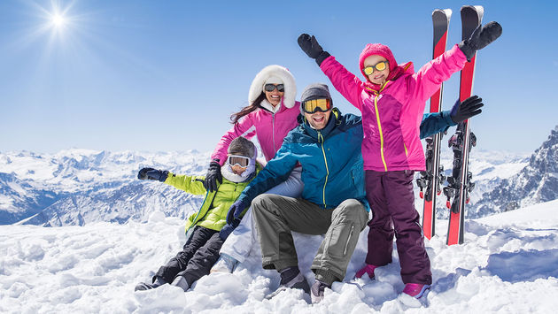 Happy family in winter holiday (Photo via Ridofranz / iStock / Getty Images Plus)