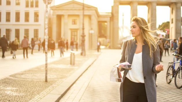 Young woman holding a city map in Berlin, Germany