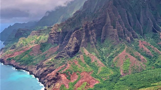 Red Green mountains and blue turquoise ocean