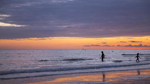 Children playing in Tampa Bay at sunset
