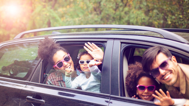 multi-ethnic family traveling by car on vacation