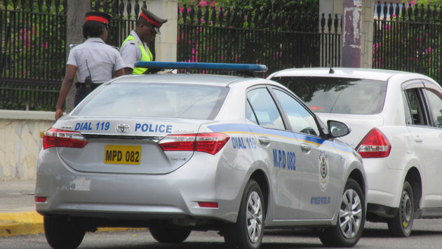 Jamaica police officers and their police car