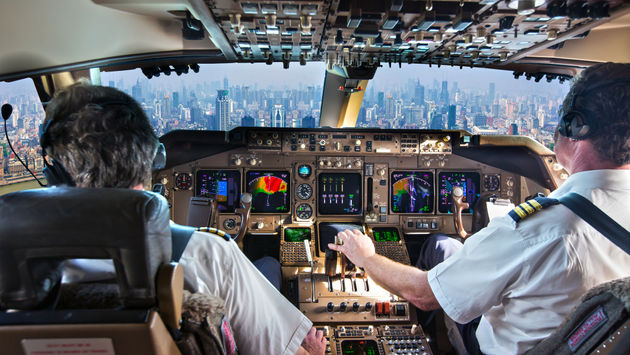Commercial passenger aircraft pilots in the cockpit.