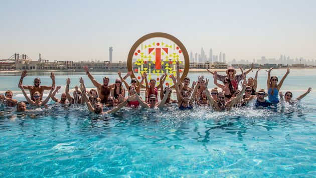 Travel industry members networking in the pool in Dubai