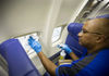 Southwest employee cleaning plane.