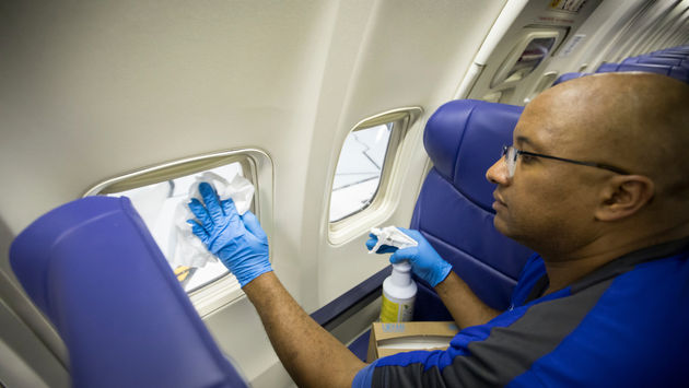 Southwest employee cleaning plane.