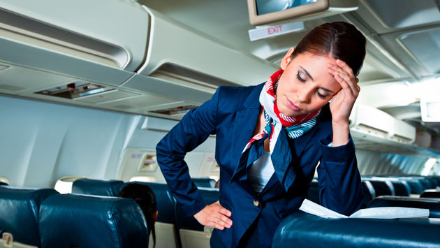 flight attendant, stewardess, plane, cabin, exhausted, frustrated, headache