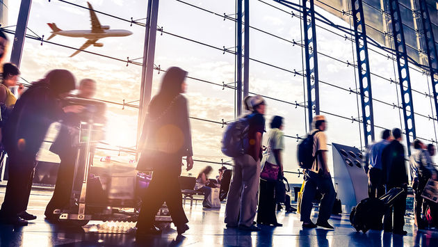 People walking through airport (Photo via 06photo / iStock / Getty Images Plus)
