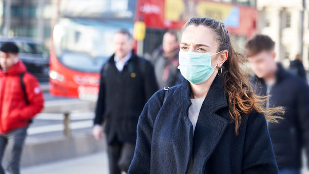 Young woman in London wearing a hygenic mask.