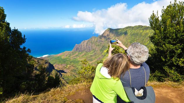 Tourist couple at Waimea Canyon State Park, Kauai, Hawaii