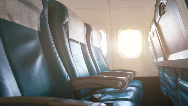Empty aircraft seats and windows with sun light
