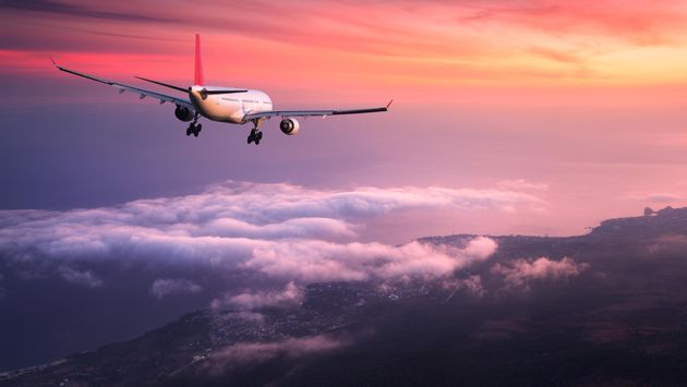 Passenger airliner is landing at dusk