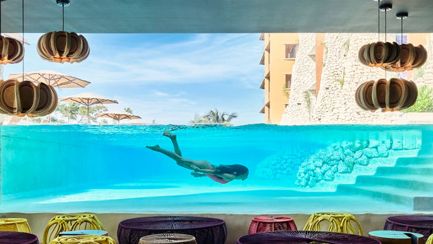 Woman enjoying a swim at Hotel Xcaret Arte