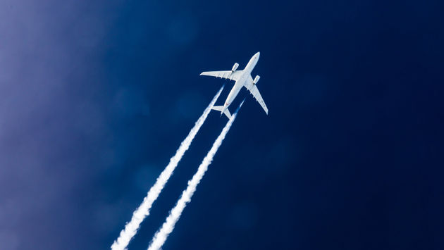The vapor trails of an Airbus 330 operated by Etihad Airways.