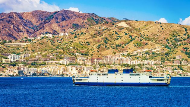 Passenger ferry in Mediterranean Sea and cityscape Messina Sicily island