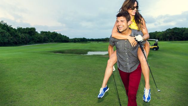 A couple playing golf on vacation