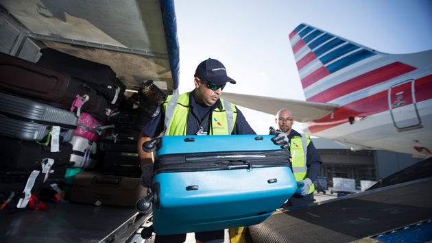 American Airlines fleet team members unloading baggage from aircraft
