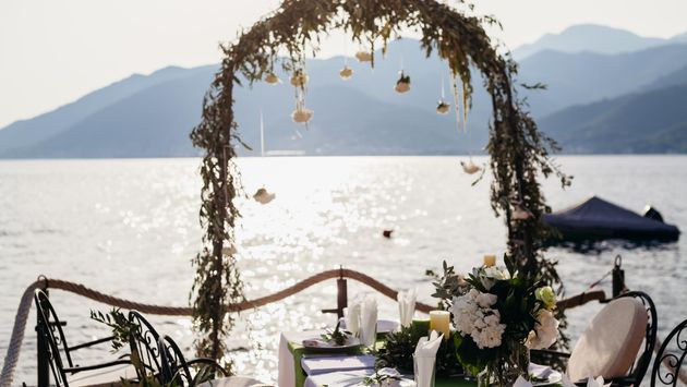 destination wedding arch and banqouet covered table at sunset