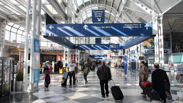 Travelers walking through Chicago's O'Hare International Airport