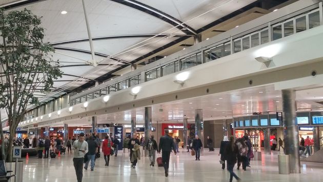 Travelers walking through a terminal at Detroit Metropolitan Airport