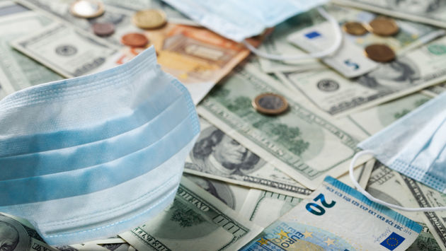 Medical face mask and money from around the world.