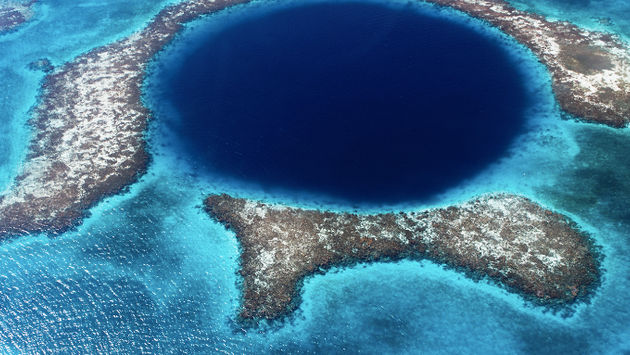 The magnificent Blue Hole is one of the natural wonders that Belize offers its visitors. (Lomingen / iStock / Getty Images Plus).
