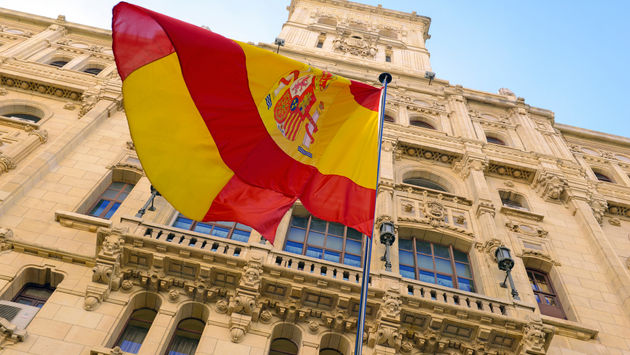 The Spanish flag flying in front of a building in Madrid.