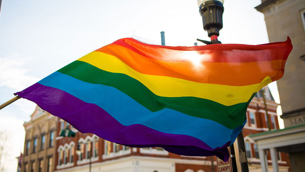 LGBT rainbow flag outside in the sun (Photo via iStock / Getty Images Plus)